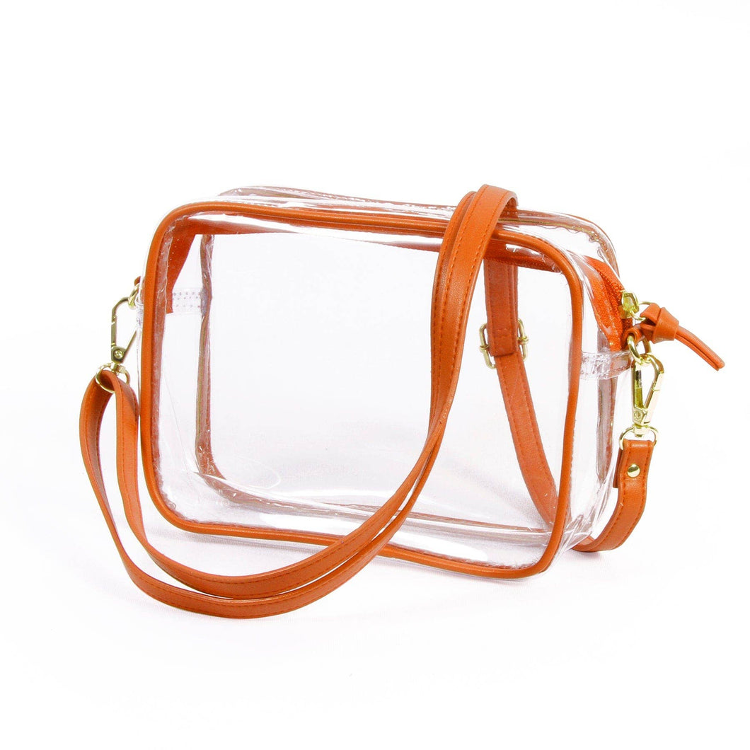 Stadium clear purse with orange vegan leather straps and accents around the edges.  It also has gold hardware and clips so the straps can be removed or changed out.  